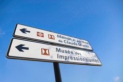 Road sign indicating the house and gardens of Claude Monet, impressionist painter in the village of Giverny in France as well as the museum.