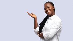 African American woman pointing both hands on upper side with smiling face. Smiling beautiful professional business African American black woman showing empty copy space on white background