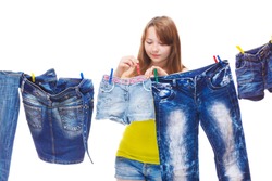 Teenage girl hanging up denim clothing for drying