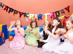 Preschool kids with soap bubbles at the birthday party