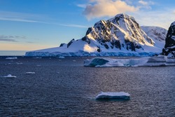Antarctic cruise ship scenic view of awe inspiring coastal Antarctic scenery from the sea at sunrise