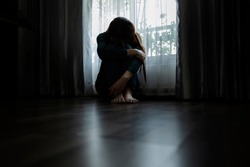 Sad young woman sitting in the bedroom, People with depression concept. Soft focus.
