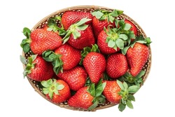 Raw ripe strawberries in a wicker basket isolated on white background, top view, close up. PNG. High quality photo