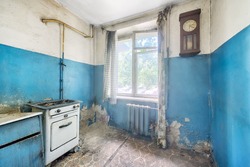 Old ugly abandoned empty kitchen in a residential building. The interior of the collapsing room of the kitchen in the house