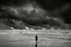 alone boy near the beach with dramatic stormy sky   during monsoon season 
