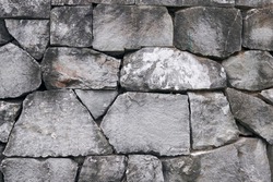 Detail of a traditional stonewall of Japanese building. Cut stone wall background.