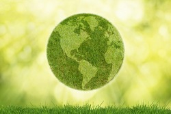 Green planet Earth with grass on green background