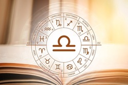 Zodiac circle against the background of an open book with libra sign. Astrological forecast for the signs of the zodiac. Characteristics of the sign libra. Astrology, esotericism, secret science
