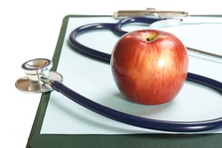 Blank clipboard with stethoscope & apple.