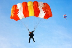 Skydiver falls through the air. Parachuting is fun!
