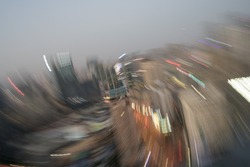 CHENGDU, CHINA - NOV 17 2021: Swirly zoom in blur of city in dusk light.