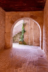 Archway to the internal backyard with no people in Sos del Rey Catolico downtown, Aragon, Spain