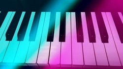 Piano keyboard in neon colors. Keys of colorful lights. Pink and blue background.