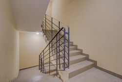 Building panel house interior with entryway and flight stairs. Precast concrete staircase. Flight of stairs. Flight of stairs are decorated building. Beautiful long staircase. Tile on floor.