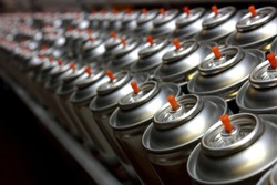 Aerosol cans on production line in factory
