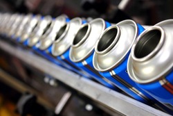 aerosol manufacturing factory showing empty cans on production line