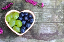 Heart shaped dish with grapes and blueberries