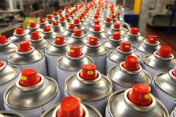 Aerosol cans in busy factory 