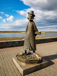 Ironic bronze monument to the Russian writer A.P. Chekhov through the eyes of a drunken man on the embankment of the Tom River. Tomsk, Siberia. Russia. Vertical Tomsk, Russia october, 2. 2022
