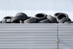 Waste rubber tires at landfill for recycling. Regenerated reuse of the waste car tyres. Pile of old wheels on tyre dump for recycling. Disposal of waste tires. Copy space.