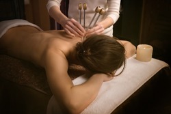 woman getting treatment. Acutonic relax massage and sound healing. Tuning forks