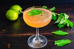 Old Cuban Cocktail Made with Rum, Mint, and Sparkling Wine: A cocktail made with dark rum and served in a coupe glass