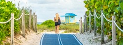 Girl walking to the beach on Footpath. South Beach in Miami, Florida, USA