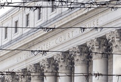 Barbed wire fence in front of United States Court House. Courthouse facade with columns, lower Manhattan, New York