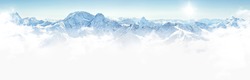 Panorama of winter mountains with clouds, bright sun and copy space