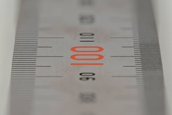Stainless steel ruler close-up - focused on 100 - High resolution metal ruler macro horizontal crop