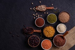 Various type of cereal grains, rice,brown rice, buckwheat, barley, ,millet. Various raw uncooked grains on dark background pulses, grains, seeds and millet.