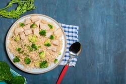 Fried rice dish with chicken breast have vegetable broccoli in plate isolated on wood background close up, top view, healthy food and drink concept.