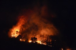 view of a mountain burning at night