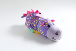 Plush soft children's toy purple dragon with colorful round spots. Turn it inside out. White background, space for text