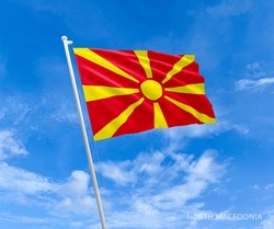Flag on North-Macedonia  flag pole and blue sky, Flag of North-Macedonia fluttering in blue sky big national symbol. Waving red and yellow North-Macedonia flag, Independence Constitution Day.