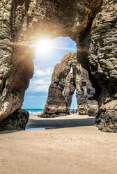 Natural rock arches Cathedrals beach (playa de las catedrales). Famous beach in Northern Spain Atlantic. Natural rock arch on Cathedrals beach in low tide (Cantabric coast, Lugo (Galicia), Spain).