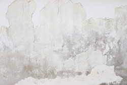 White  grey old  wall with shabby damaged plaster Cement and brick background of an vintage dirty exfoliating plaster  Textured background peeling of colour wallpaper cement