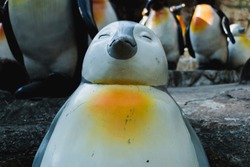 The penguin statue feels happy.