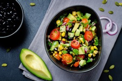 Black beans corn avocado red onion tomato salad with lime dressing. toning. selective focus