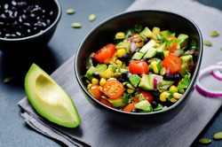 Black beans corn avocado red onion tomato salad with lime dressing. toning. selective focus