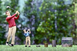 Lifelike resin figure of an adult and child golfer. with piles of silver and gold coins arranged in sequence with blurry trees in the background