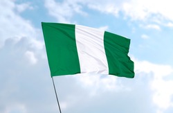 Flag of Nigeria in front of blue sky