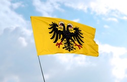 Holy Roman Empire flag in front of blue sky