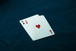Two aces on a dark table. Ace of Spades and Ace of Hearts. Casino concept