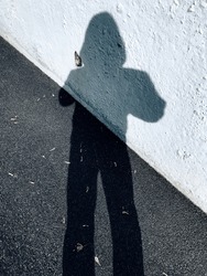 Long shadow of a man. Male shadow on the pavement