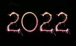 2022 written with Sparkle firework on black background written horizontally, happy new year 2022 concept.