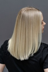Straight hair after bleaching process. Look from behind. Hair care