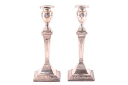 An antique pair of silver candlesticks of column form