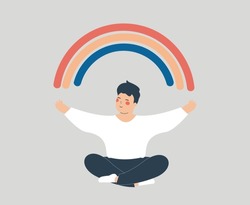 Happy man sits in yoga lotus pose with outstretched arms to create positive vibes around him. Teenage male open his arms to the rainbow and enjoys his life freedom. Mental health wellbeing concept.