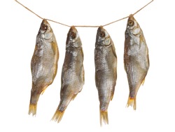 four delicious dried fish hanging on a beige rope twine on a white background